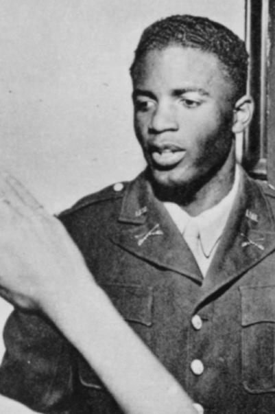  Robinson in his Army uniform, ca. 1943, during a visit to his home in Pasadena, California, receiving a military salute from his nephew Frank