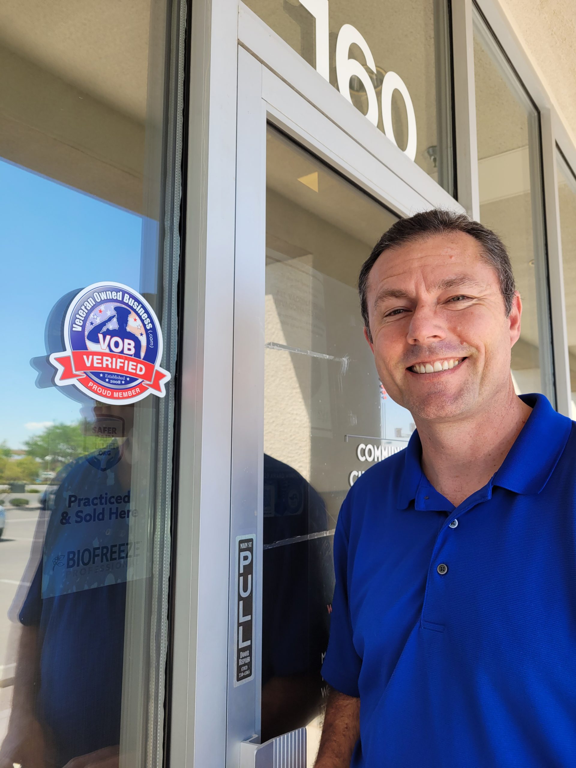 Dr. Spencer Eaton of Community Chiropractic Center showing his Veteran Owned Business Project "Verified Member" sticker on his business' front entrance!
